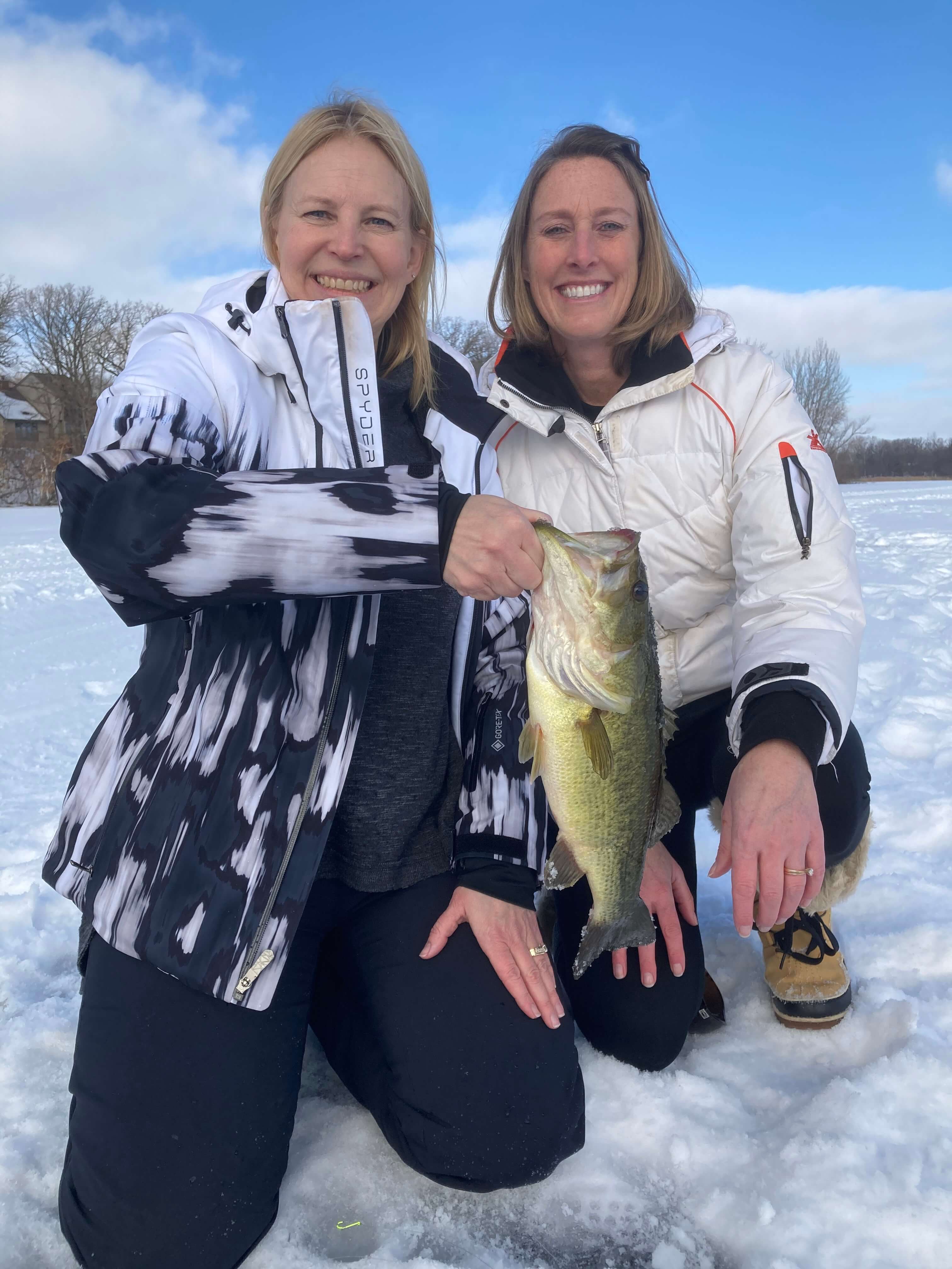 Two girls with bass caught ice fishing