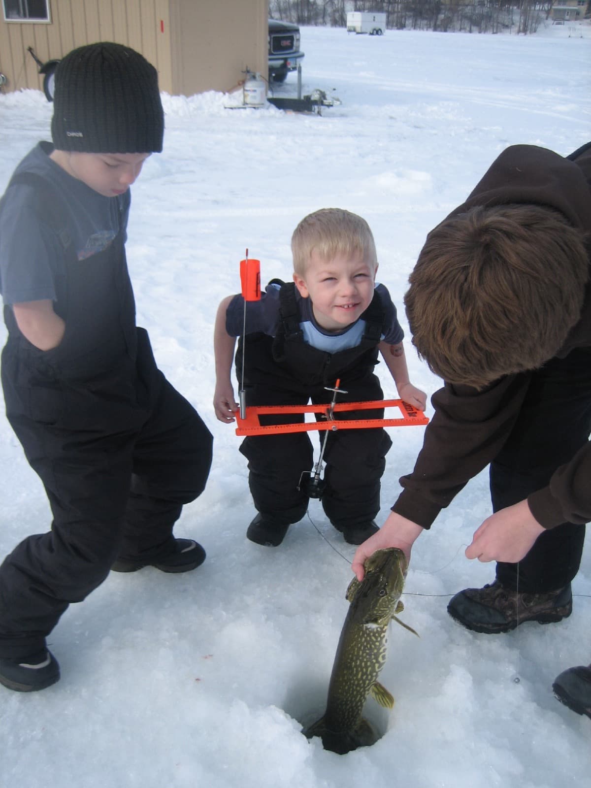 Boys running a tip-up for pike