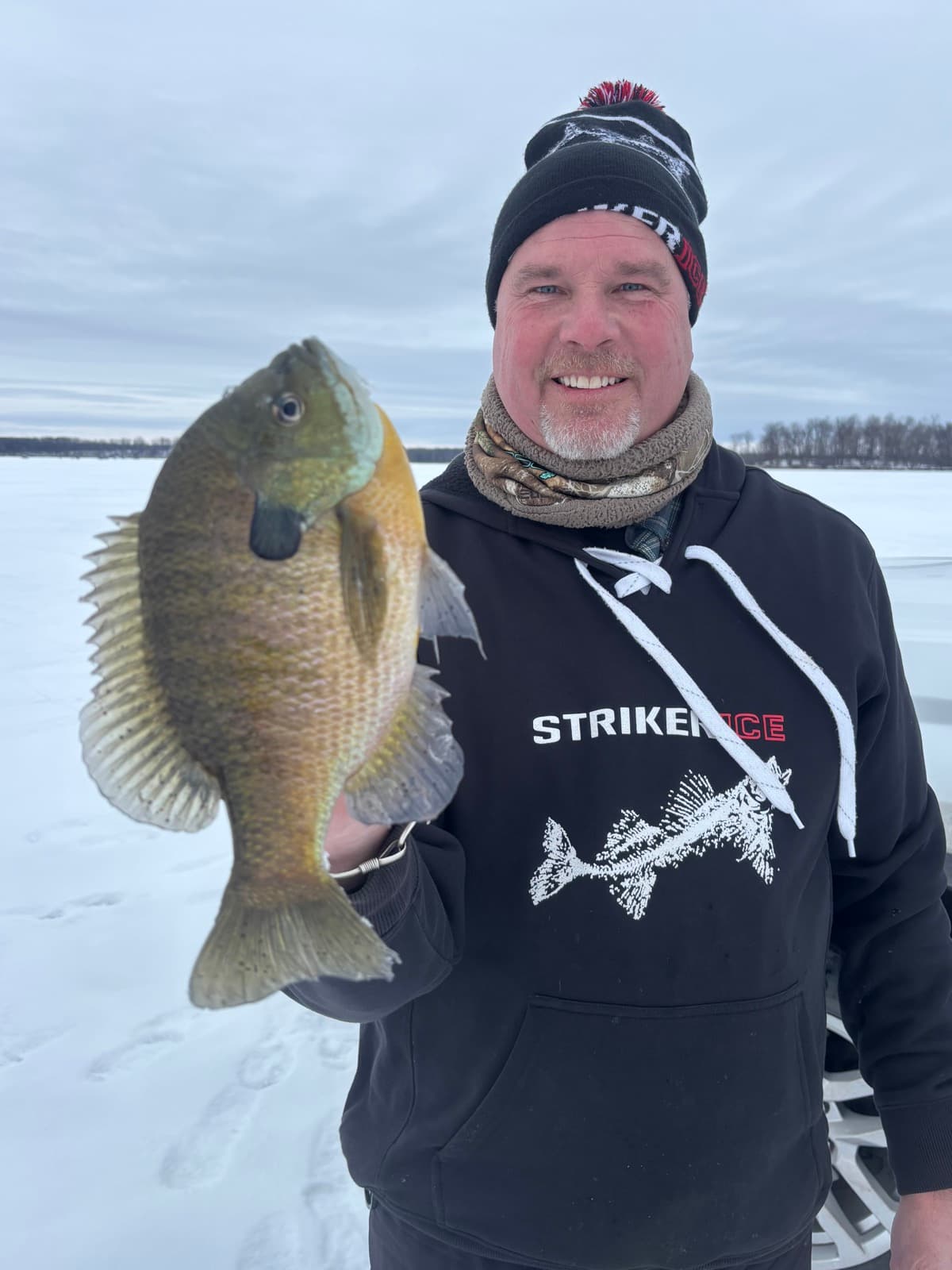 Captain Josh with a huge bluegill and Striker