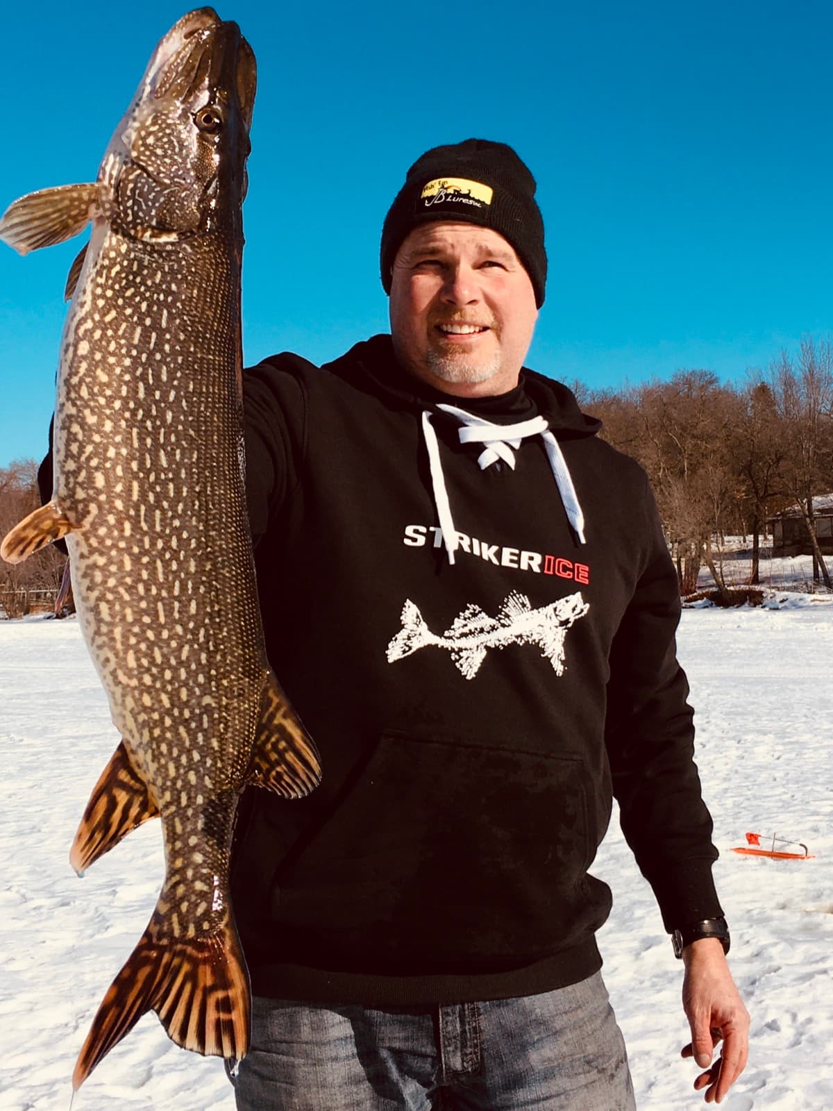 Captain Josh with a pike close-up on JB Lures and Striker