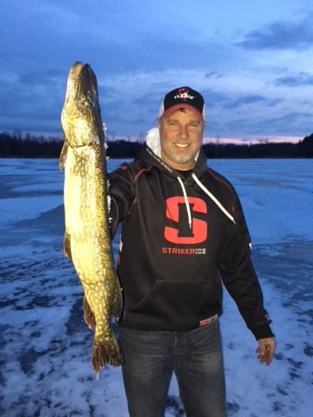 Captain Josh with pike while ice fishing